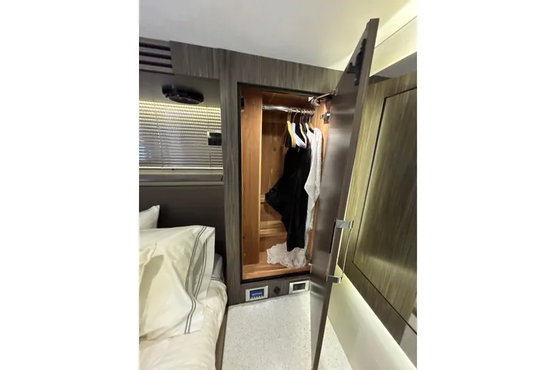 Slide: The Image of Luxurious cabin closet in 2018 Sea Ray Sundancer 510 yacht, featuring elegant wood finish. - 141