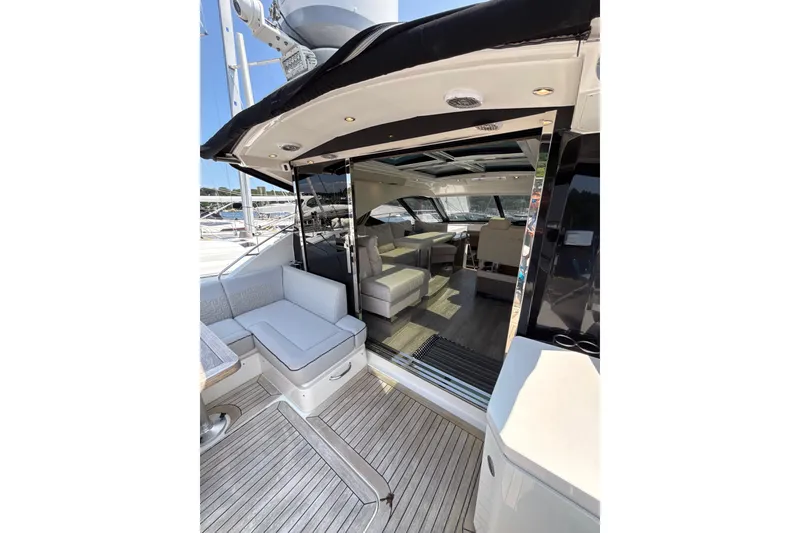 Slide: The Image of 2018 Sea Ray Sundancer 510 yacht interior with seating and open deck view. - 95