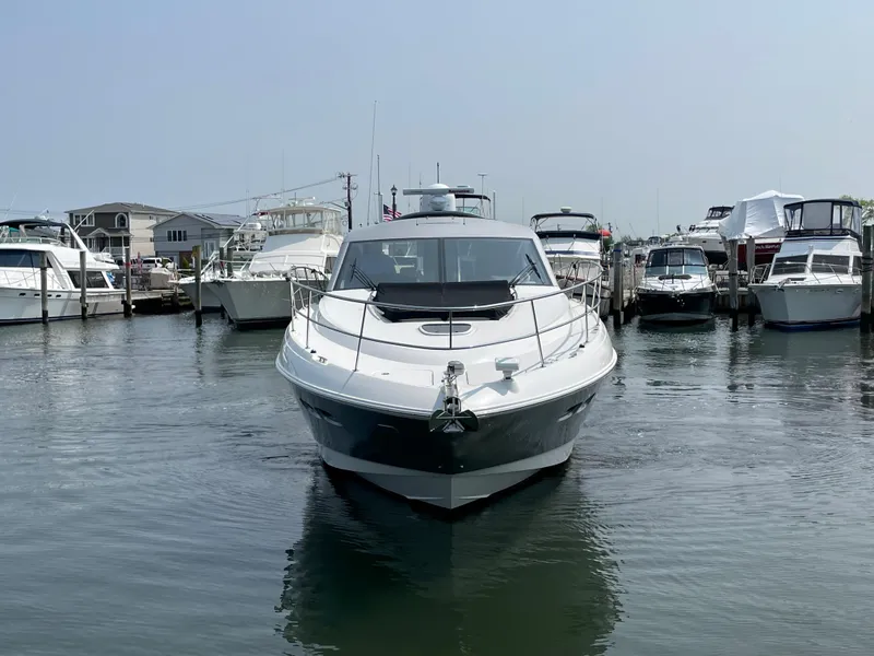 Slide: The Image of A 2018 Sea Ray Sundancer 510 is docked in a busy marina. - 19
