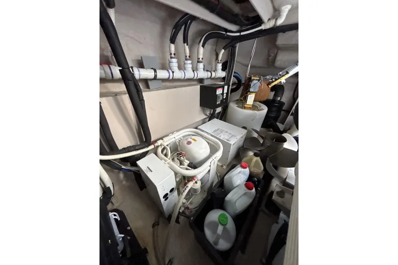 Slide: The Image of Engine room of 2018 Sea Ray Sundancer 510 with mechanical components and storage containers. - 123