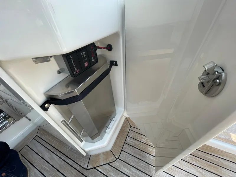 Slide: The Image of A storage compartment on a Sea Ray Sundancer 510 boat with a secured metal container. - 46
