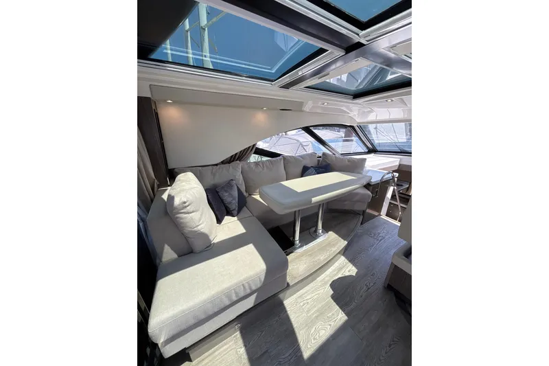 Slide: The Image of Luxurious interior of 2018 Sea Ray Sundancer 510 yacht with plush seating and skylight. - 104