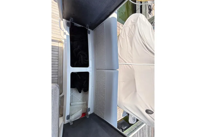 Slide: The Image of 2018 Sea Ray Sundancer 510 storage compartment with ropes and cover. - 145