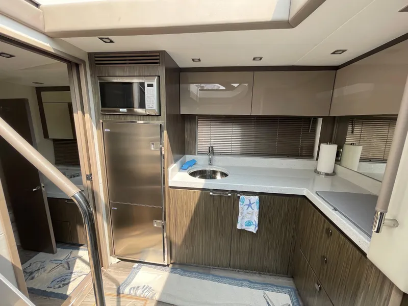 Slide: The Image of The 2018 Sea Ray Sundancer 510 kitchen features modern appliances and ample storage space. - 61