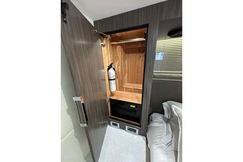 Slide: The Image of 2018 Sea Ray Sundancer 510 interior closet with fire extinguisher and storage space. - 142