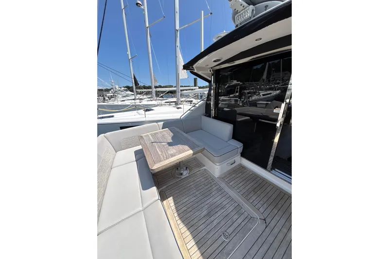 Slide: The Image of 2018 Sea Ray Sundancer 510 yacht with elegant outdoor seating and wooden deck. - 109