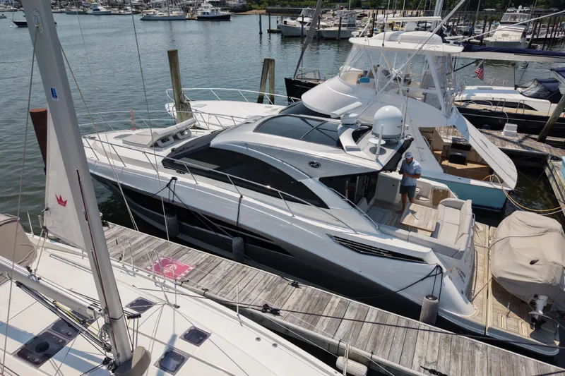 Slide: The Image of 2018 Sea Ray Sundancer 510 yacht docked at marina, surrounded by other boats. - 78