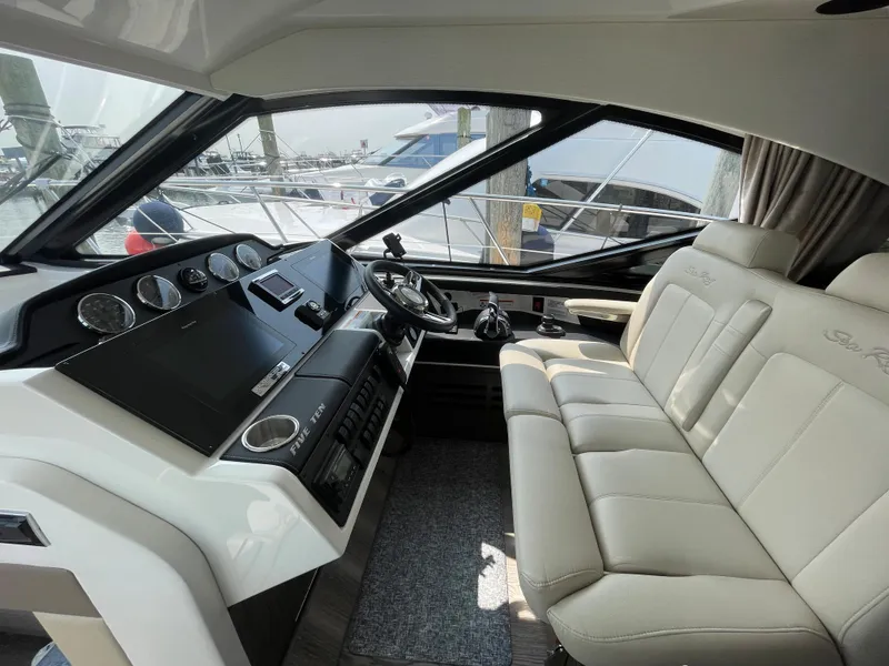 Slide: The Image of The image shows the cockpit of a 2018 Sea Ray Sundancer 510 with modern instruments and comfortable seating. - 53
