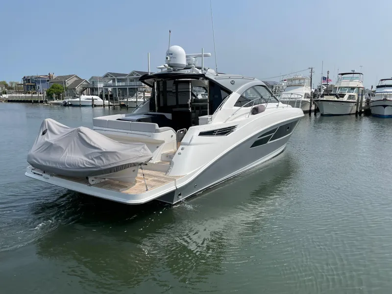 Slide: The Image of A 2018 Sea Ray Sundancer 510 is in the water. It features a sleek, modern design. - 2