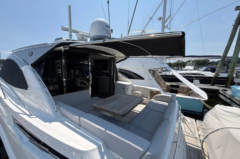 Slide: The Image of 2018 Sea Ray Sundancer 510 yacht with spacious deck and seating area at marina. - 89