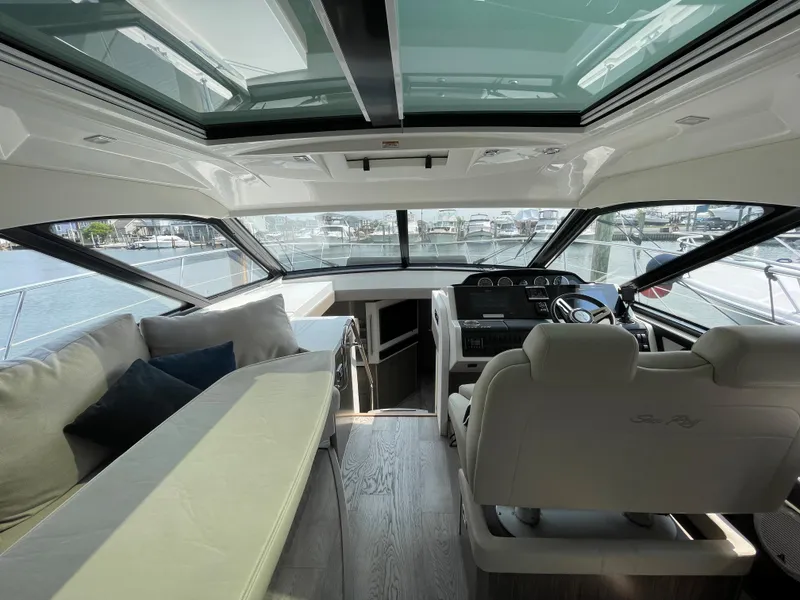 Slide: The Image of Interior of a 2018 Sea Ray Sundancer 510 with panoramic windows and a sleek seating area. - 49