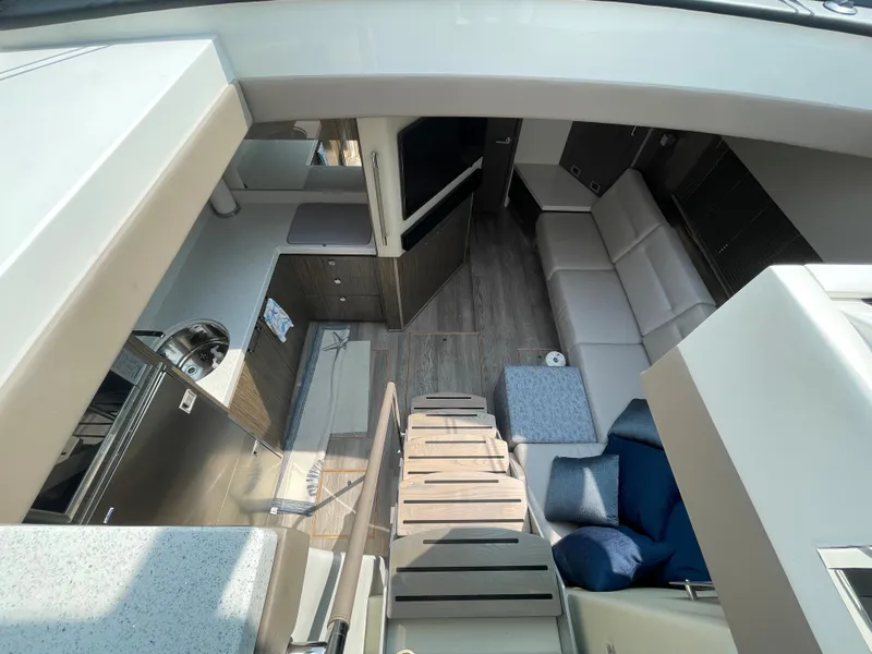 Slide: The Image of Interior view of a 2018 Sea Ray Sundancer 510 with modern kitchen and cozy living area. - 55