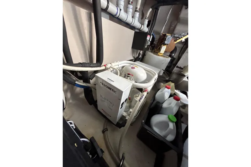 Slide: The Image of Engine room of 2018 Sea Ray Sundancer 510 with Dometic equipment and various containers. - 126