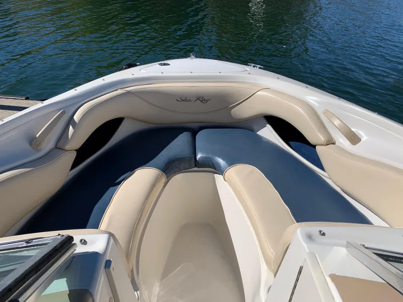 Slide: The Image of 2000 Sea Ray 210 Bow Rider boat interior with cushioned seating. - 10