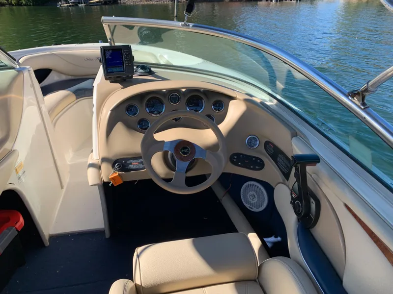 Slide: The Image of Interior view of a 2000 Sea Ray 210 Bow Rider boat's helm and dashboard. - 11