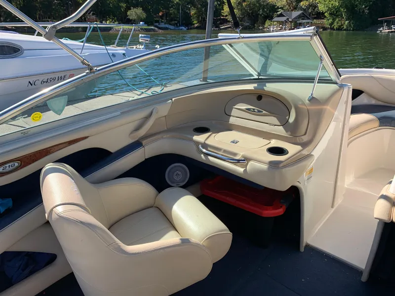 Slide: The Image of Interior of a 2000 Sea Ray 210 Bow Rider boat with beige seating. - 12