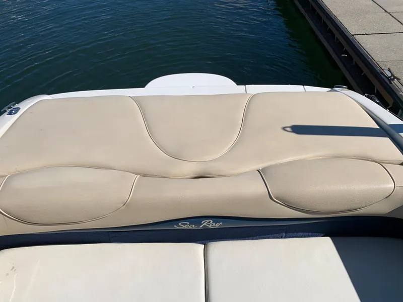 Slide: The Image of Sea Ray 210 Bow Rider 2000 boat's rear seating area by the water. - 16