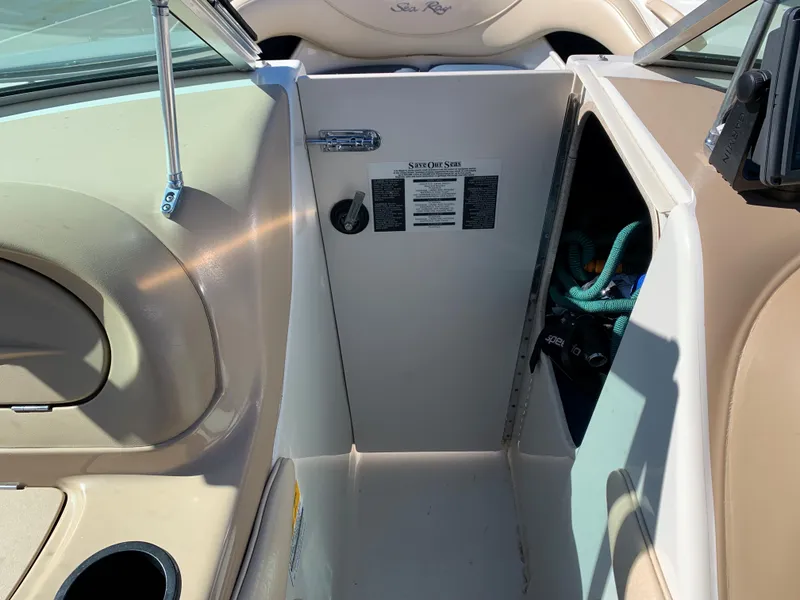 Slide: The Image of Interior view of a 2000 Sea Ray 210 Bow Rider boat showing storage compartment. - 19
