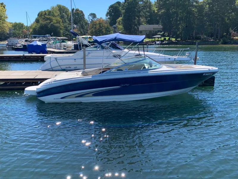 Slide: The Image of 2000 Sea Ray 210 Bow Rider docked on a sunny day. - 2