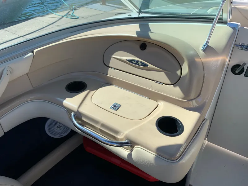 Slide: The Image of Interior of a 2000 Sea Ray 210 Bow Rider boat with cup holders and storage compartments. - 21