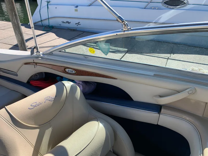 Slide: The Image of Interior of a 2000 Sea Ray 210 Bow Rider boat with beige seating. - 22