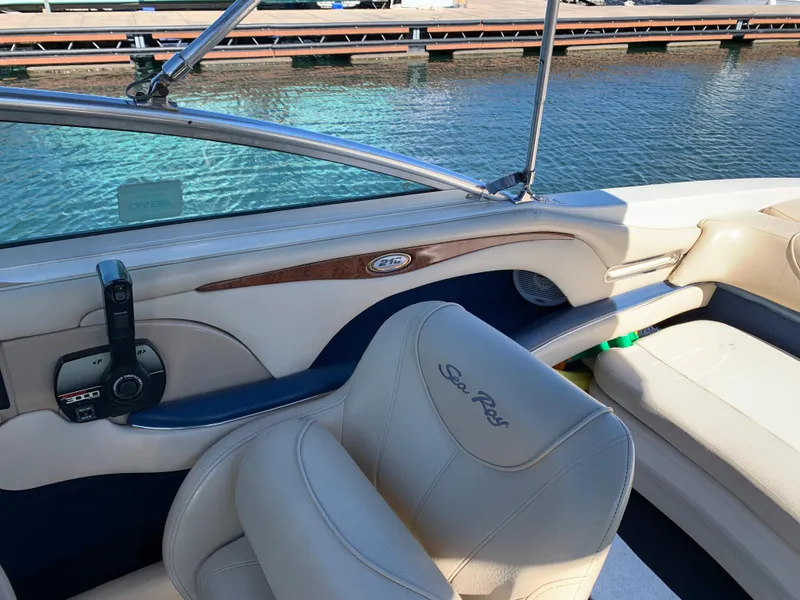 Slide: The Image of Interior of a 2000 Sea Ray 210 Bow Rider boat with cream leather seats. - 23