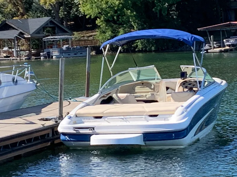 Slide: The Image of 2000 Sea Ray 210 Bow Rider docked on a sunny day. - 4