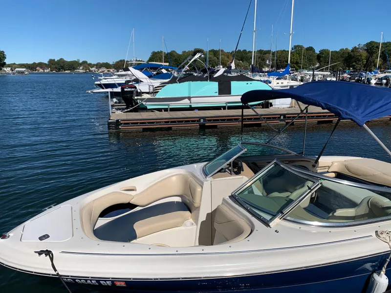 Slide: The Image of Sea Ray 210 Bow Rider 2000 model docked at a marina on a sunny day. - 7