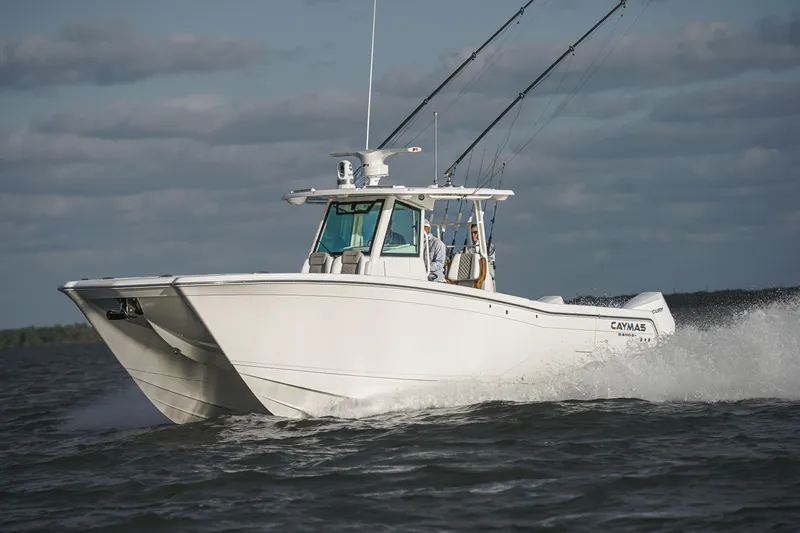 Slide: The Image of 2024 Caymas 34 CT boat cruising on open water. - 13