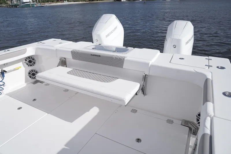Slide: The Image of 2024 Caymas 34 CT boat with Mercury engines, spacious deck, and foldable seating. - 2
