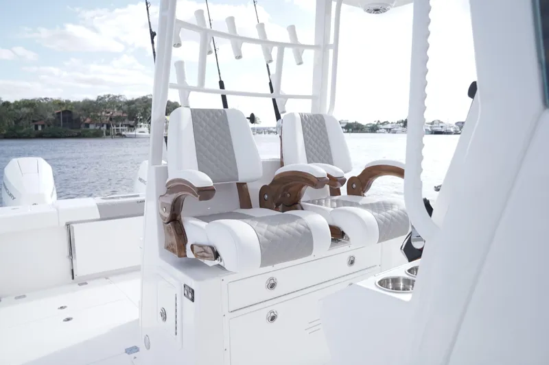Slide: The Image of 2024 Caymas 34 CT boat with luxurious seating and fishing rod holders. - 3