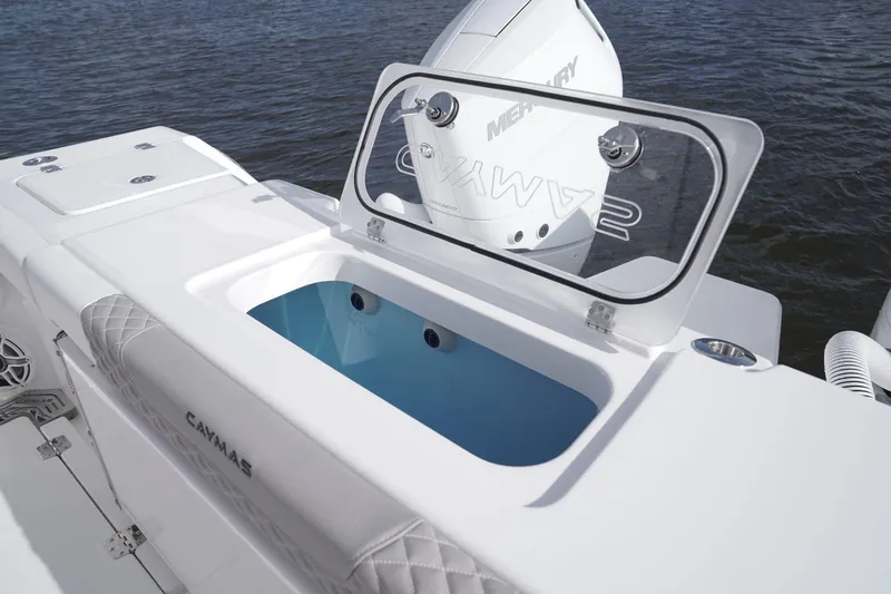 Slide: The Image of 2024 Caymas 34 CT boat with open livewell and Mercury outboard engine. - 9