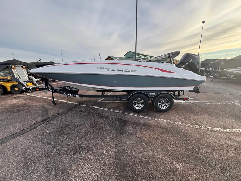 Slide: The Image of 2023 Tahoe 2150 boat on trailer in parking lot, side view. - 0