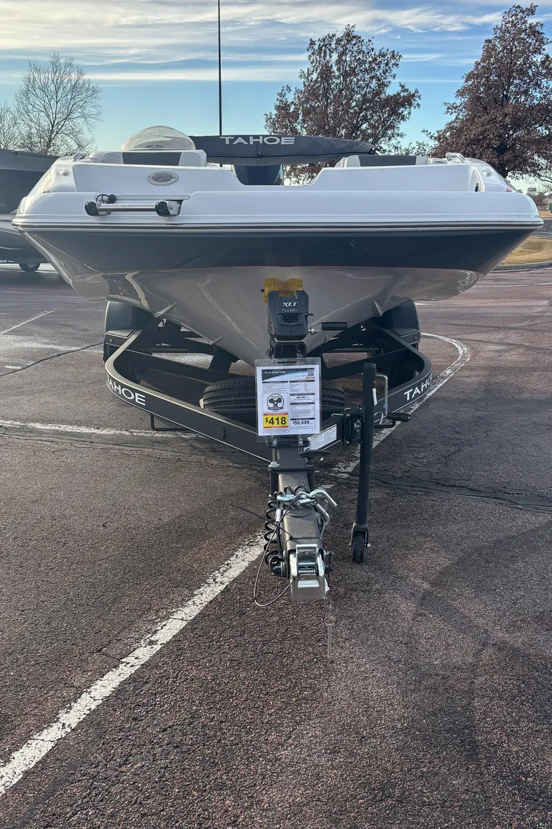 Slide: The Image of 2023 Tahoe 2150 boat on trailer in parking lot, front view. - 2