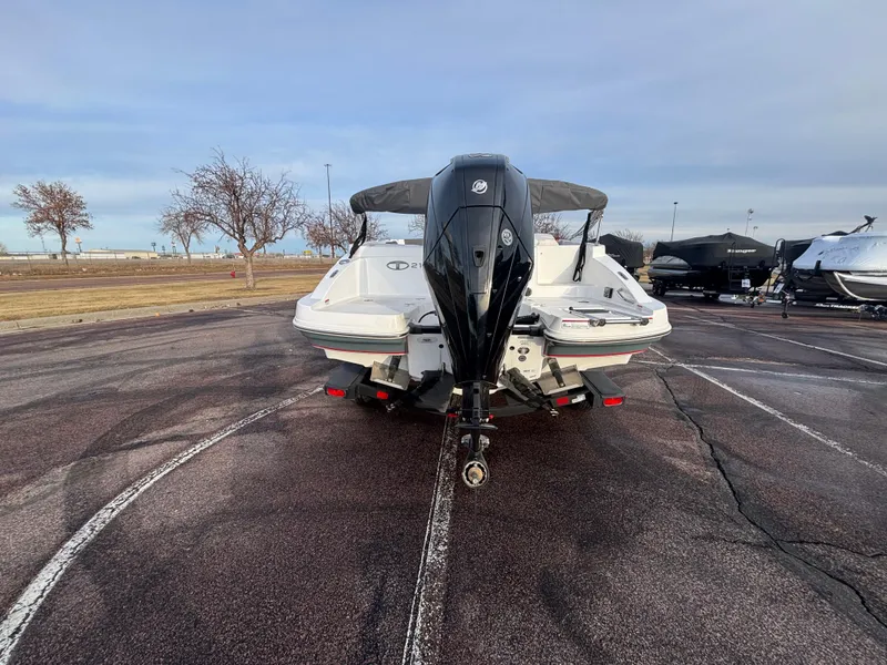 Slide: The Image of 2023 Tahoe 2150 boat with outboard motor on a trailer in a parking lot. - 5