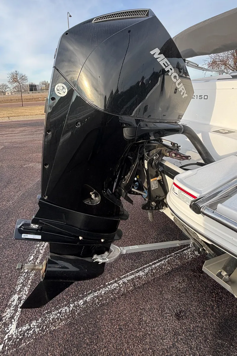 Slide: The Image of 2023 Tahoe 2150 boat with Mercury outboard motor in a parking lot. - 6