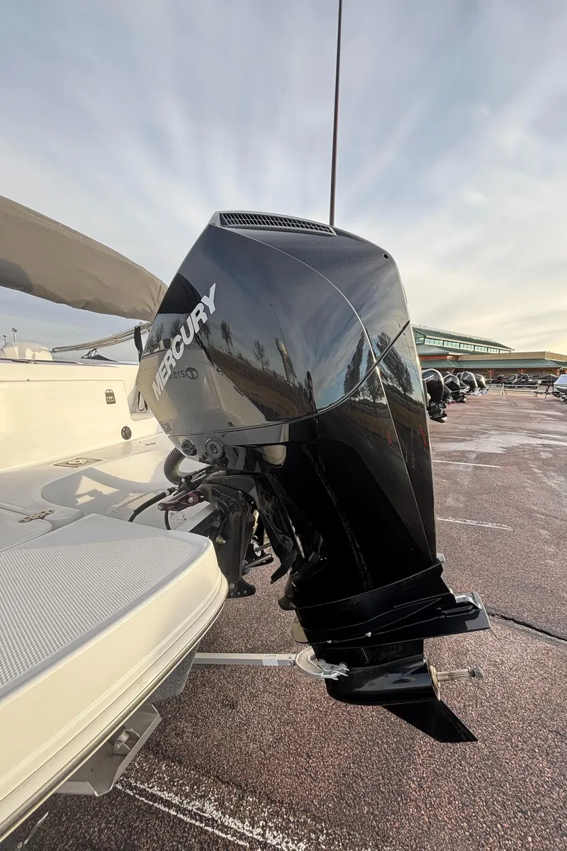 Slide: The Image of 2023 Tahoe 2150 boat with Mercury outboard motor in a marina setting. - 7
