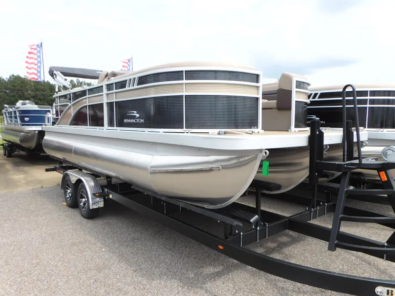 Slide: The Image of 2023 Bennington 22 SXSRC pontoon boat on a trailer, side view. - 0