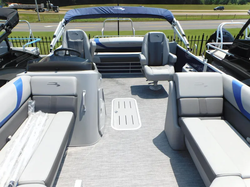 Slide: The Image of 2023 Bennington 22 SX Swingback pontoon boat interior with gray and blue seating. - 4
