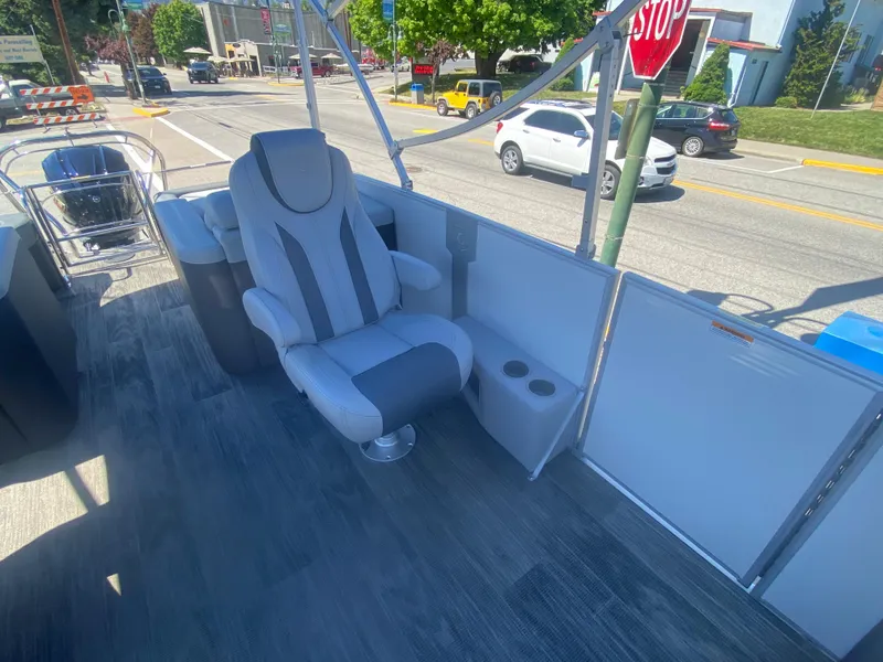 Slide: The Image of 2023 Godfrey Monaco 235 Rear Lounge boat interior with captain's chair and cup holders. - 4