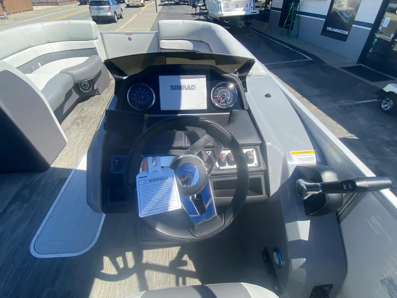 Slide: The Image of 2023 Godfrey Monaco 235 Rear Lounge boat dashboard and steering wheel. - 6
