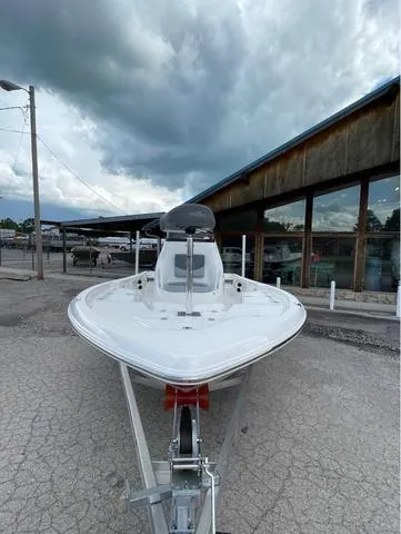 Slide: The Image of 2023 NauticStar 215 Bay boat on trailer, front view, cloudy sky background. - 3