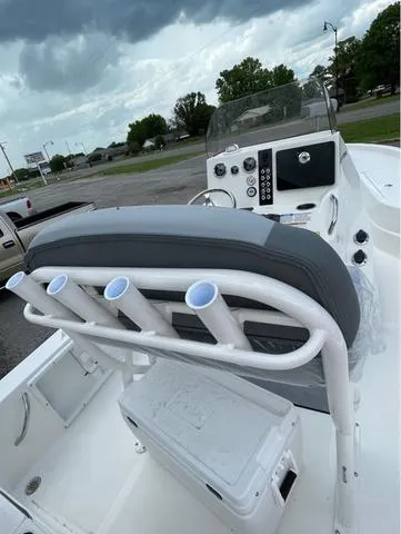 Slide: The Image of 2023 NauticStar 215 Bay boat interior with rod holders and console. - 6