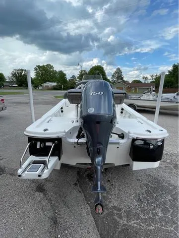 Slide: The Image of 2023 NauticStar 215 Bay boat with 150 HP engine, rear view. - 7