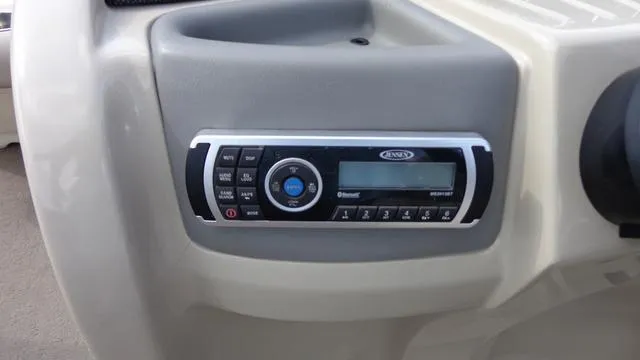 Slide: The Image of 2014 Avalon Wind Jammer boat dashboard with stereo system. - 11