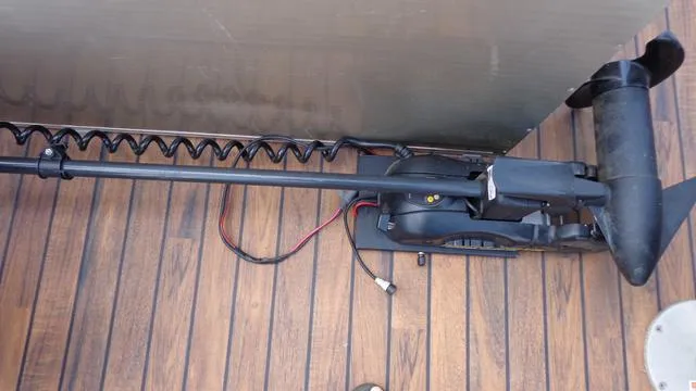 Slide: The Image of 2014 Avalon Wind Jammer boat motor on wooden deck. - 13