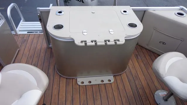 Slide: The Image of 2014 Avalon Wind Jammer boat interior with seating and storage unit. - 4