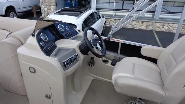 Slide: The Image of 2014 Avalon Wind Jammer boat cockpit with steering wheel and control panel. - 6