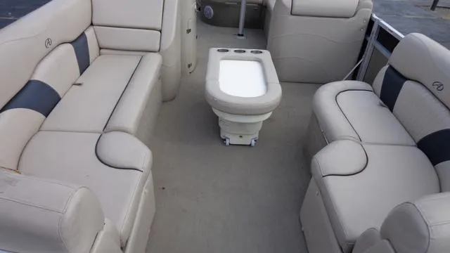 Slide: The Image of 2014 Avalon Wind Jammer boat interior with beige seating and central table. - 9