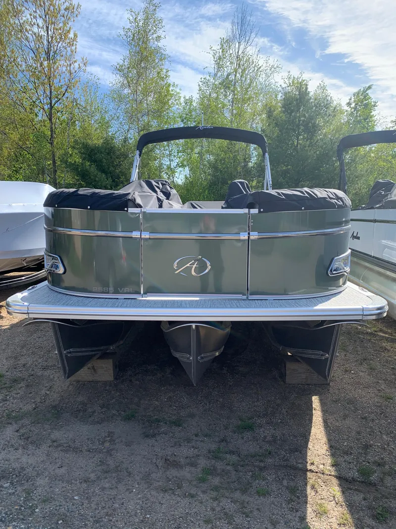 Slide: The Image of 2023 Avalon Catalina VRL 25' Tri-Toon boat, rear view, parked on land. - 10